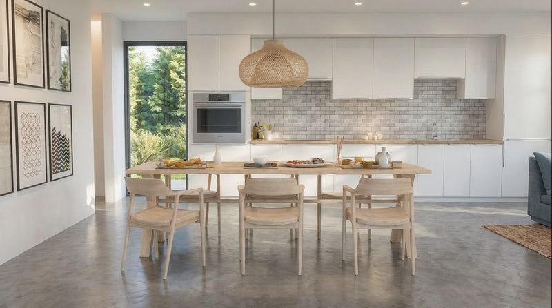 A modern dining room scene with a light wood dining table and six matching wooden chairs, set in a bright contemporary kitchen with white cabinets, a tiled backsplash, and a large window.